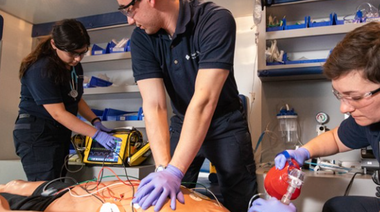 Three students practice resuscitation