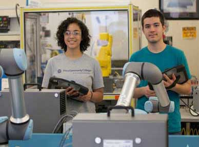 Two students in the machining lab