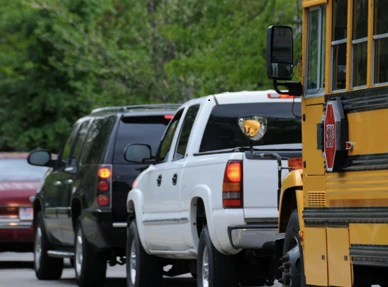 Cars and school bus in traffic