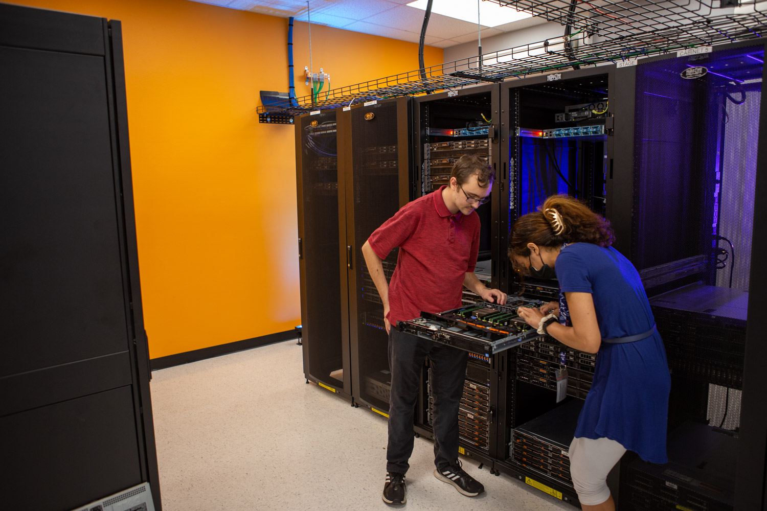 students interacting with computer servers on a rack